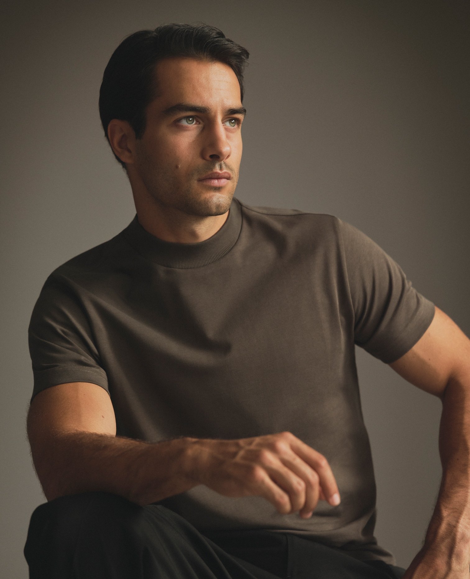 Model in a brown T-Shirt, seated