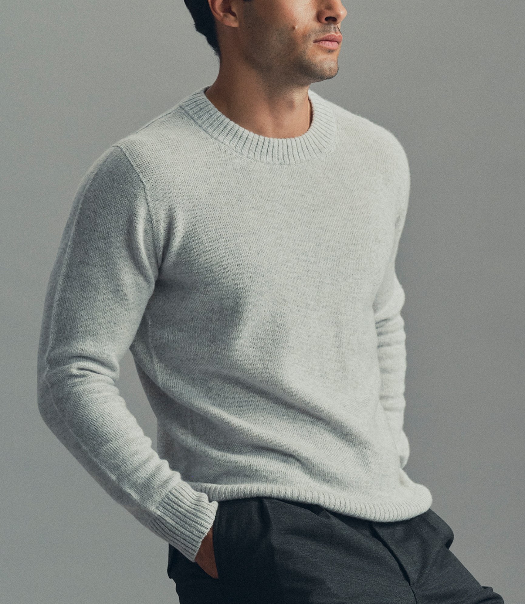 Model in a pale grey crew-neck knit