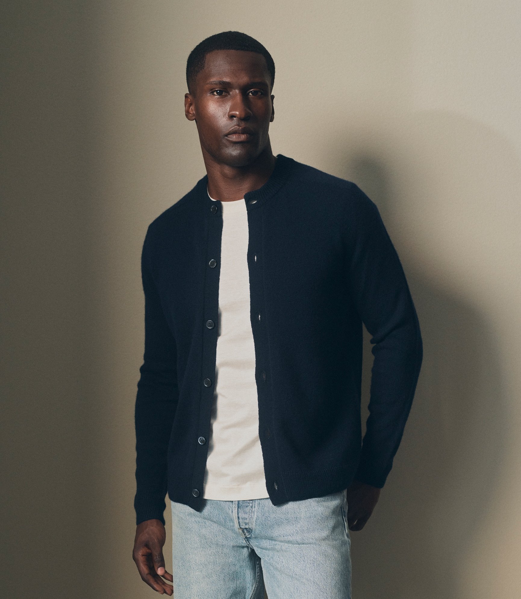 Model in a navy overshirt over a white T-Shirt with light denim jeans