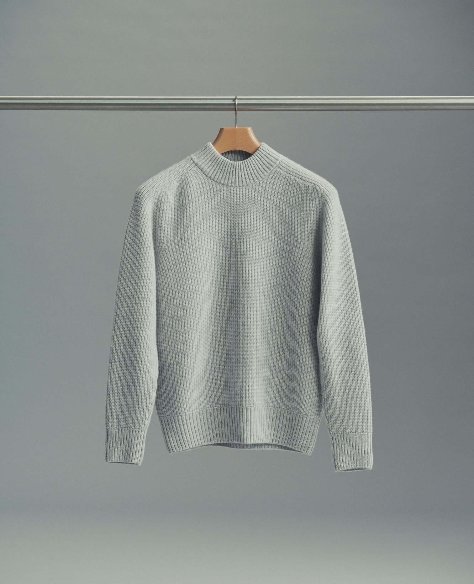 Pale grey turtleneck on a hanger