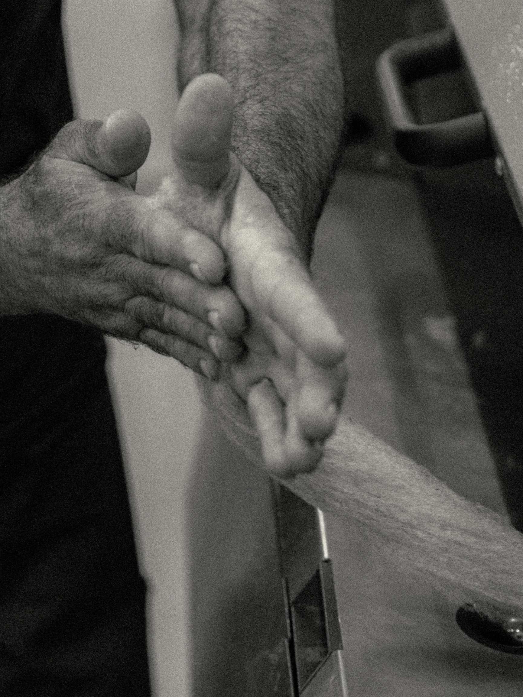 Hands at work on the production floor in black and white