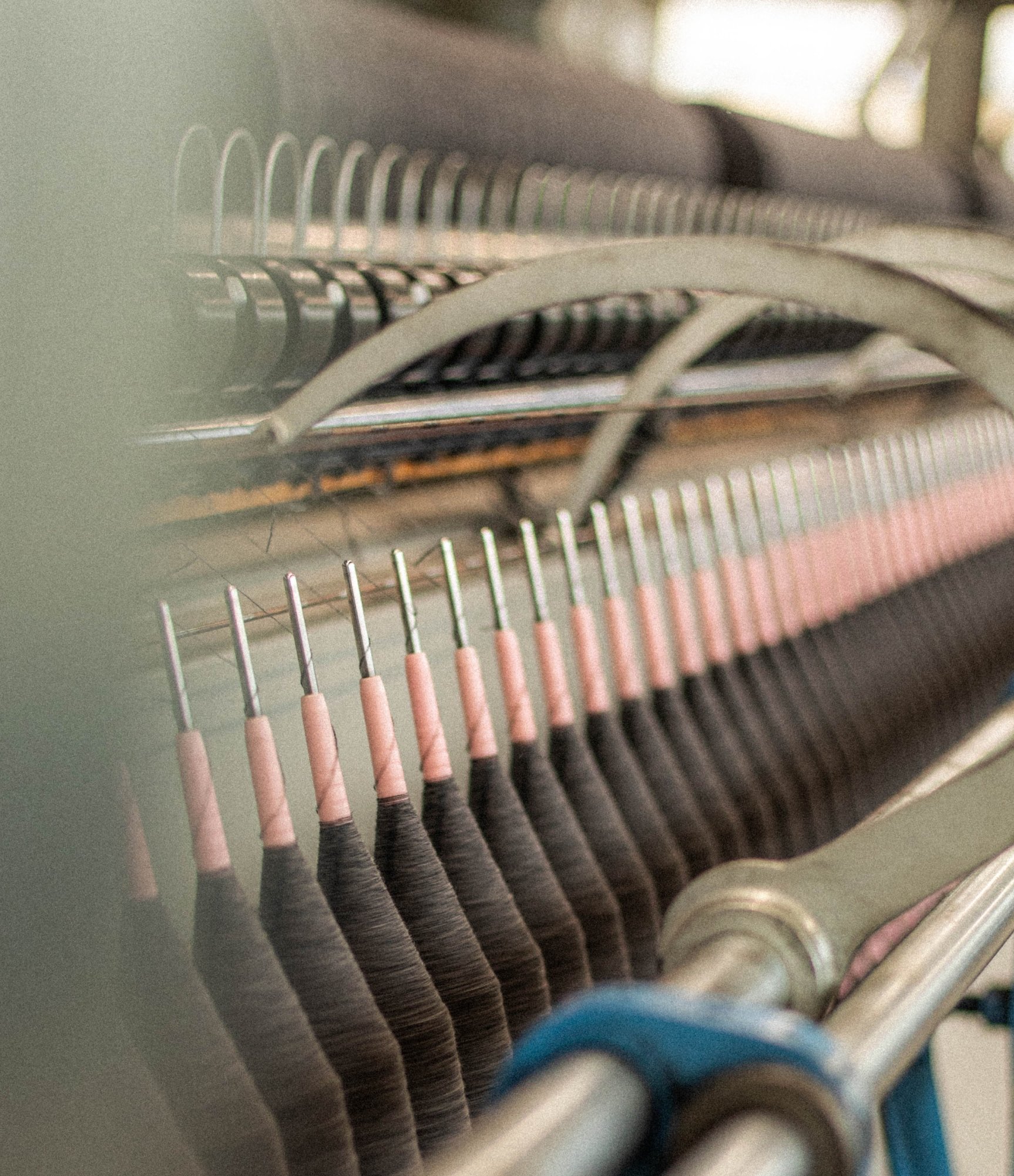 Close-up of yarn feeding through a knitting machine