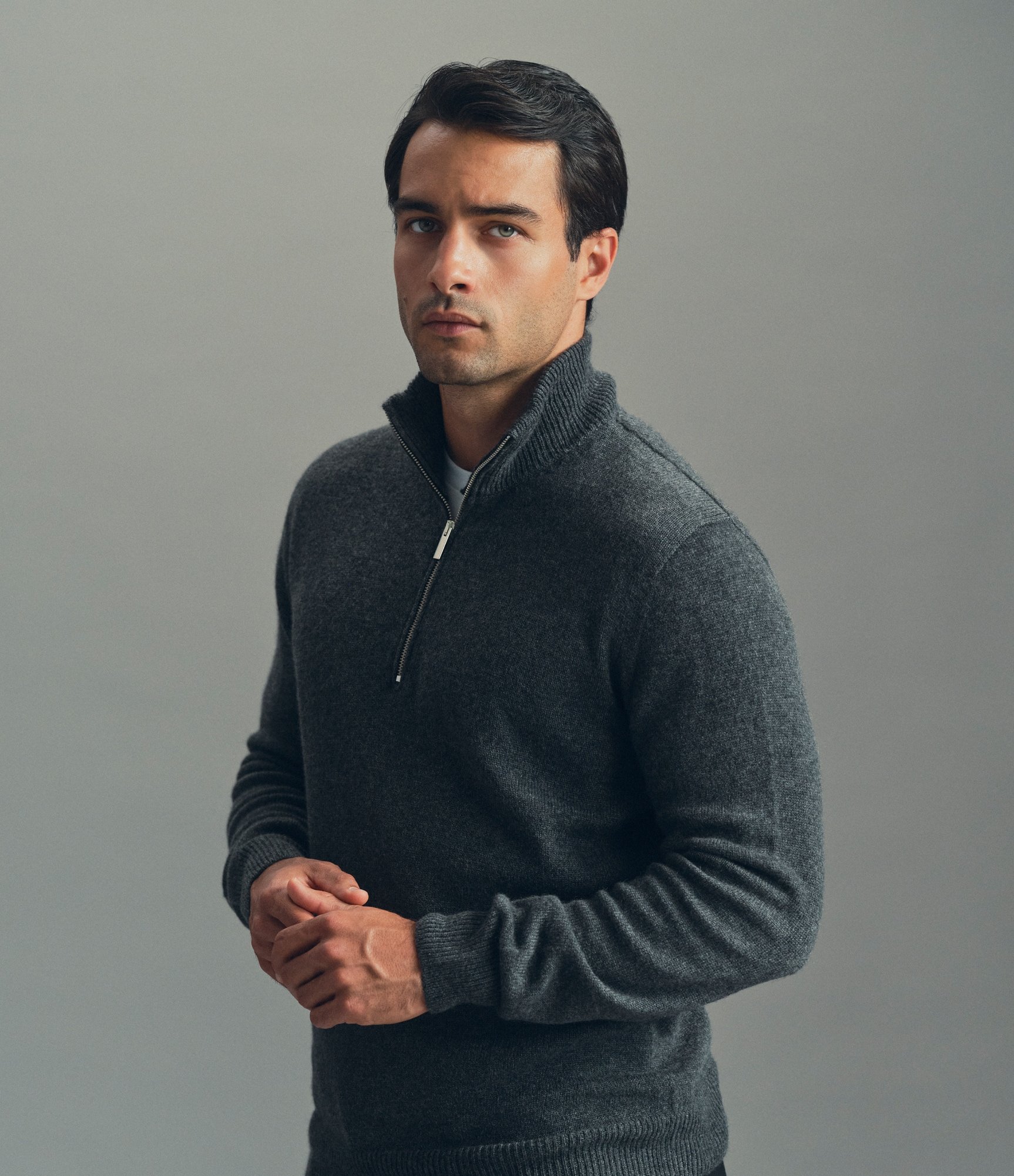 Model wearing our cashmere half-zip sweater in dark grey