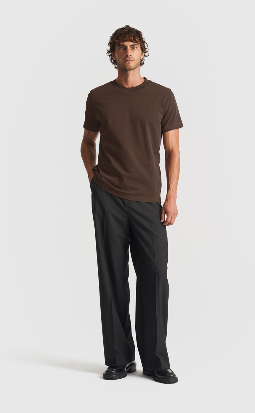 Model wearing our extra heavy cotton t-shirt in black olive
