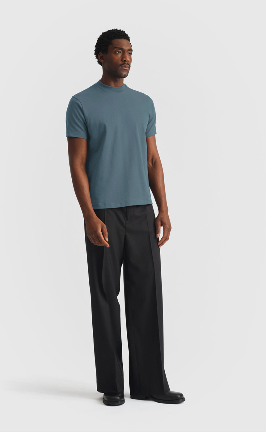 Model wearing extra heavy cotton hi-neck t-shirt in dark slate