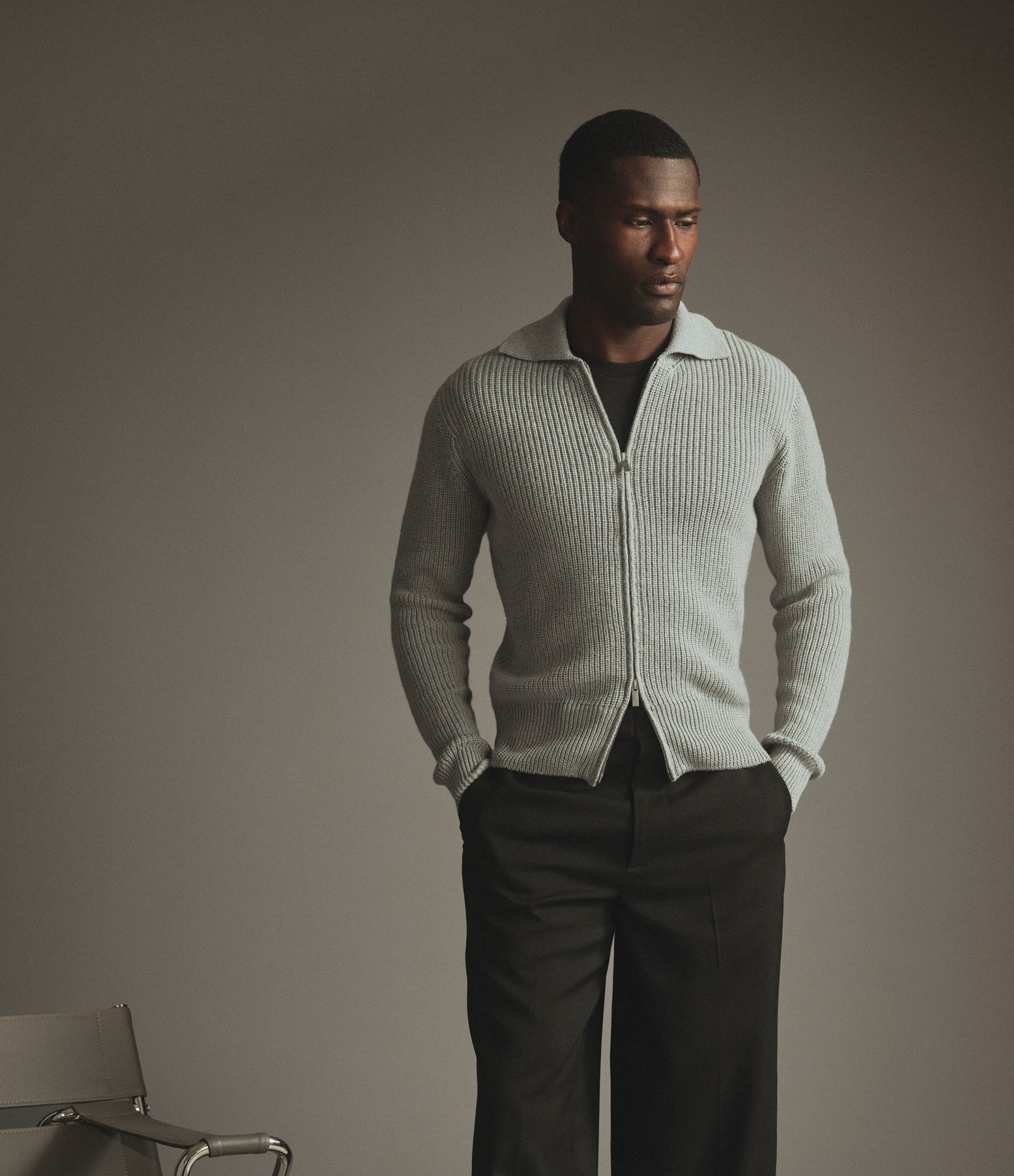 Model wearing our heavy merino zip-sweater in light grey
