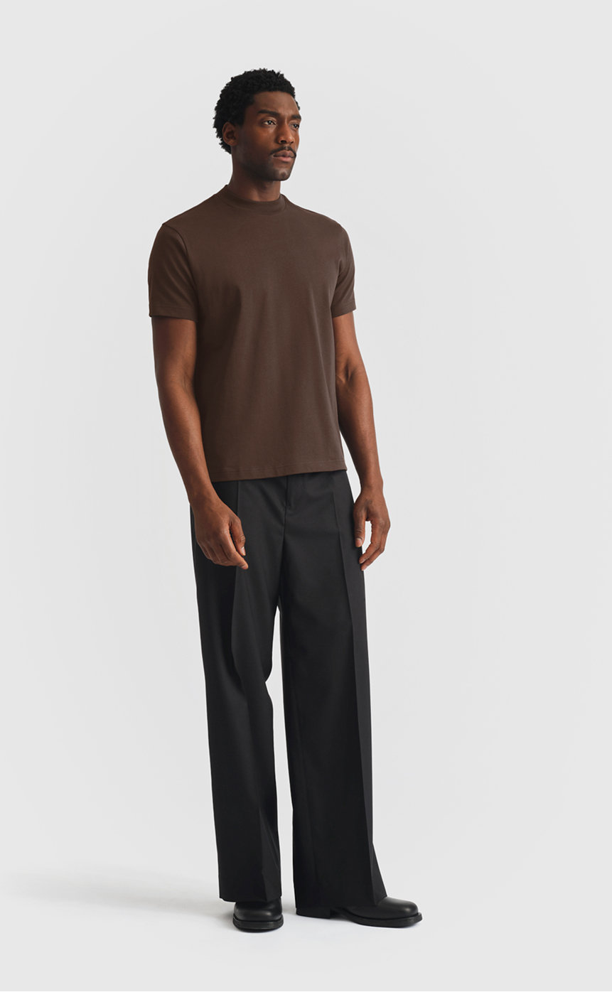Model wearing extra heavy cotton hi-neck t-shirt in black olive