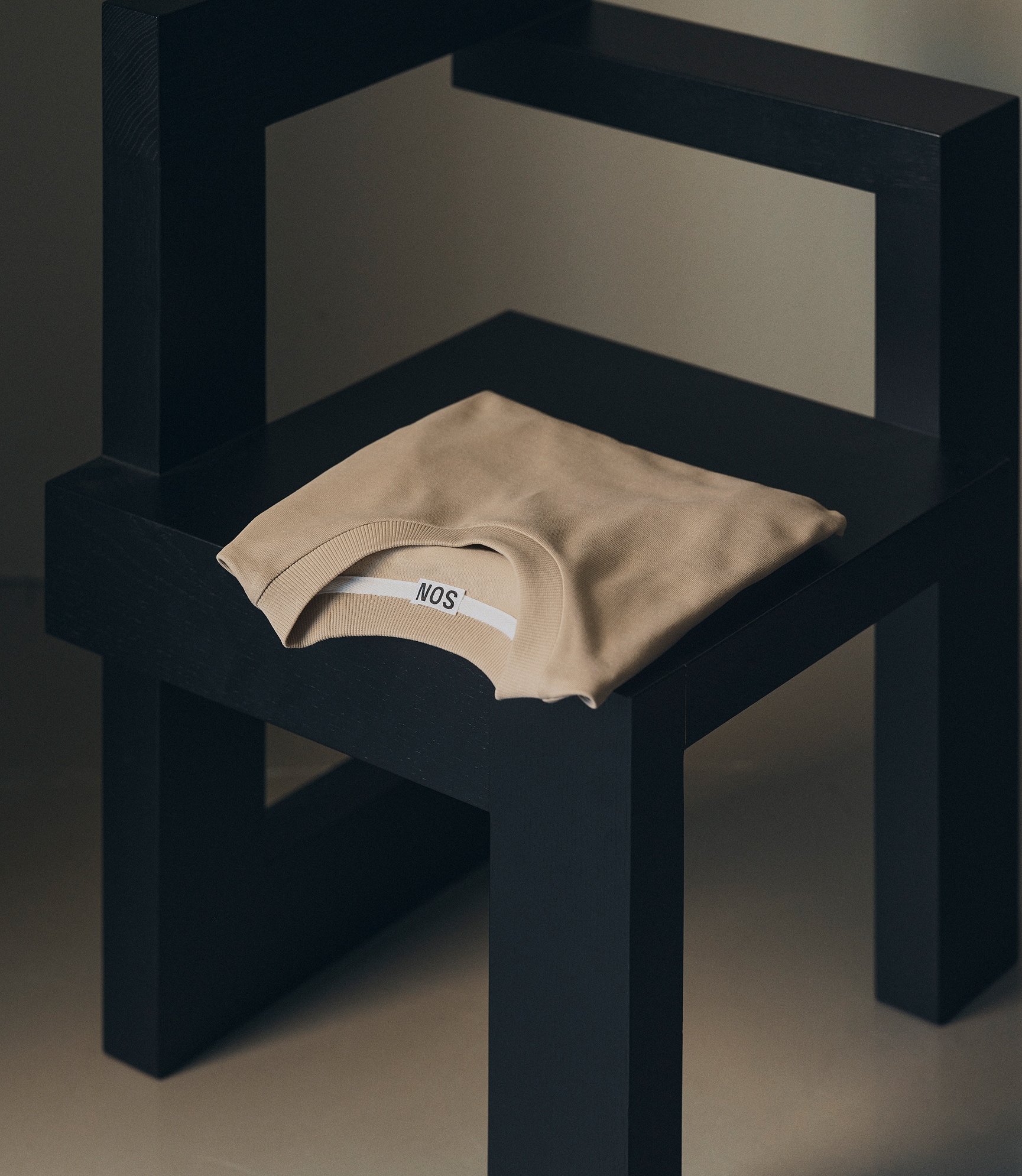 Extra heavy cotton t-shirt in plaza taupe folded on a chair
