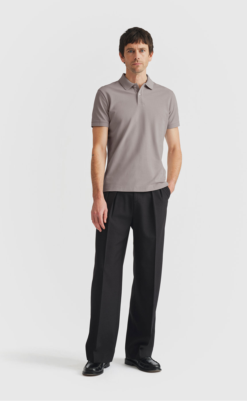 Model wearing our pique polo shirt in zinc