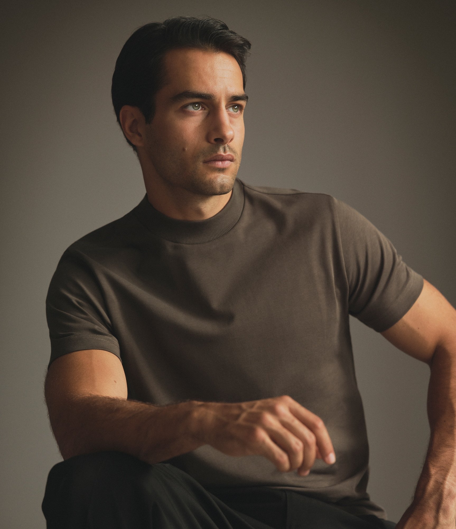 Model wearing our Extra Heavy Cotton Hi-Neck T-Shirt in Black Olive