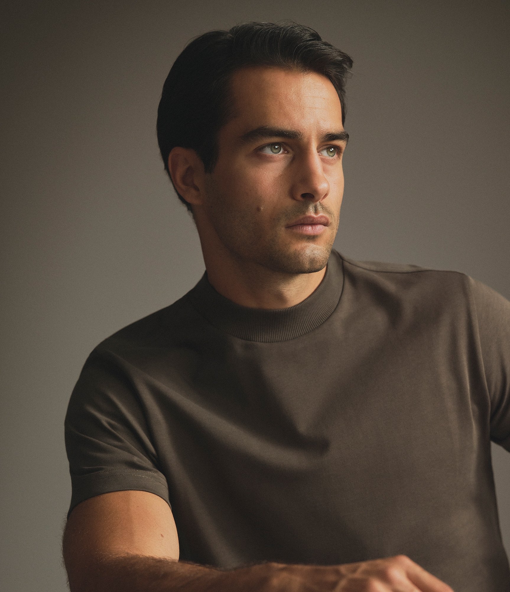 Model wearing our extra heavy cotton hi neck t-shirt in black olive