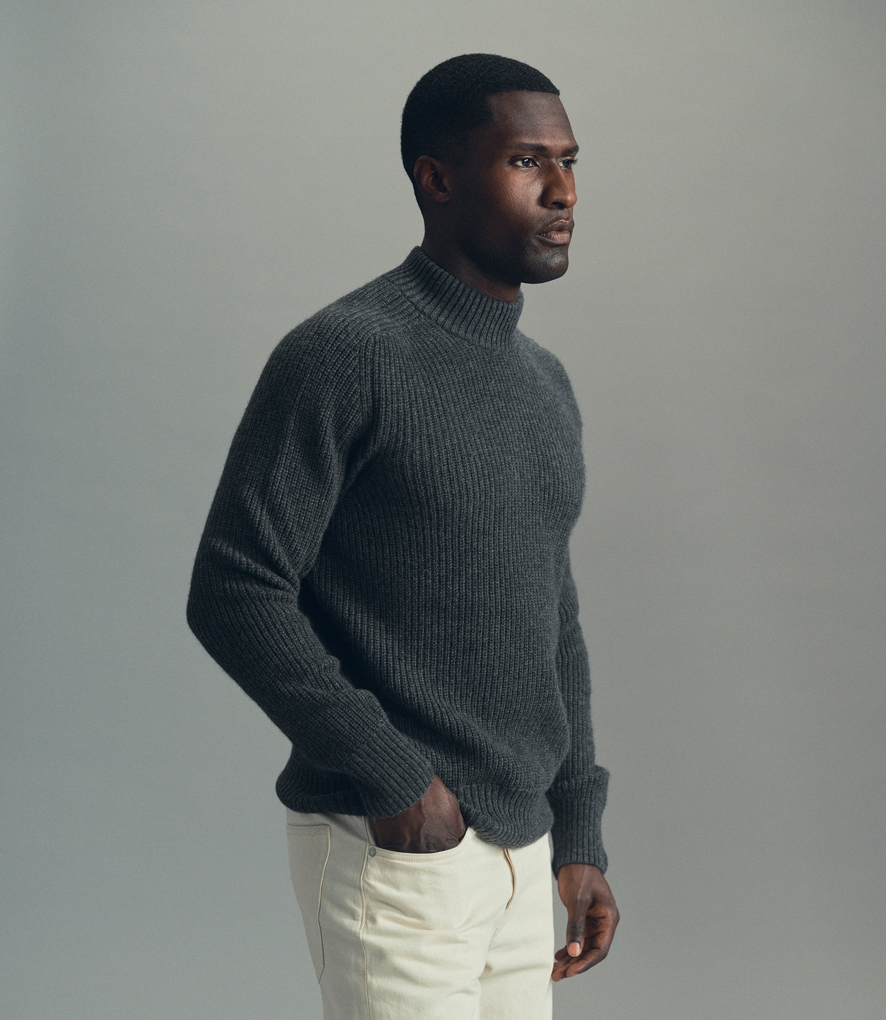 Model wearing our cashmere hi-neck sweater in anthracite