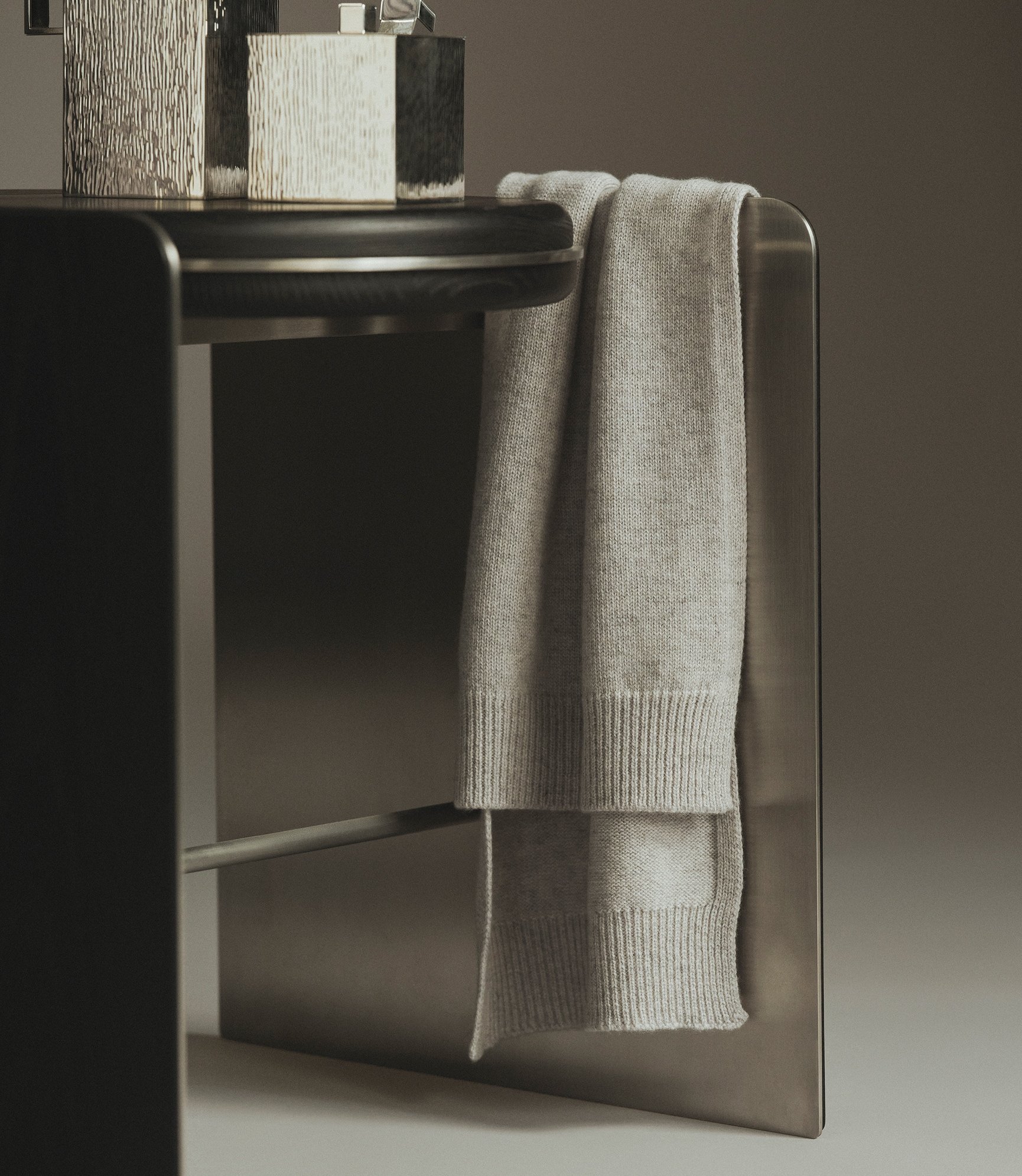 Cashmere Scarf in Light Grey Melange hanging over a chair