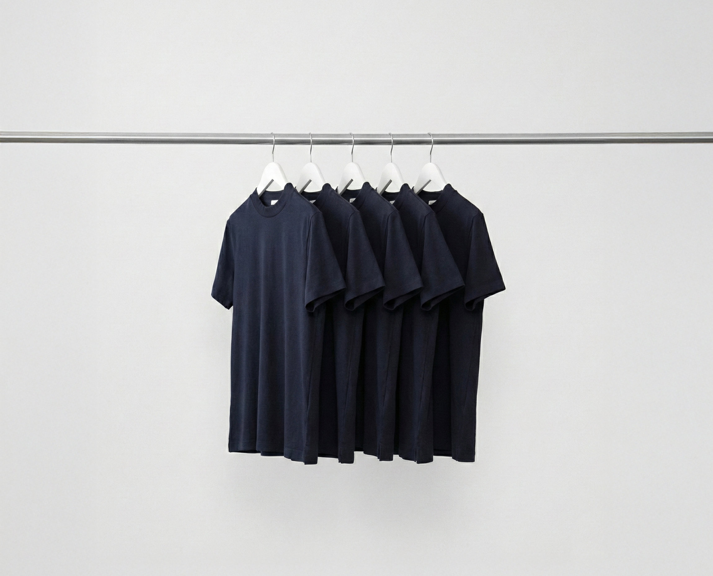 Deep Blue Hi-Necks bundle t-shirts hanging on a rack against a grey background