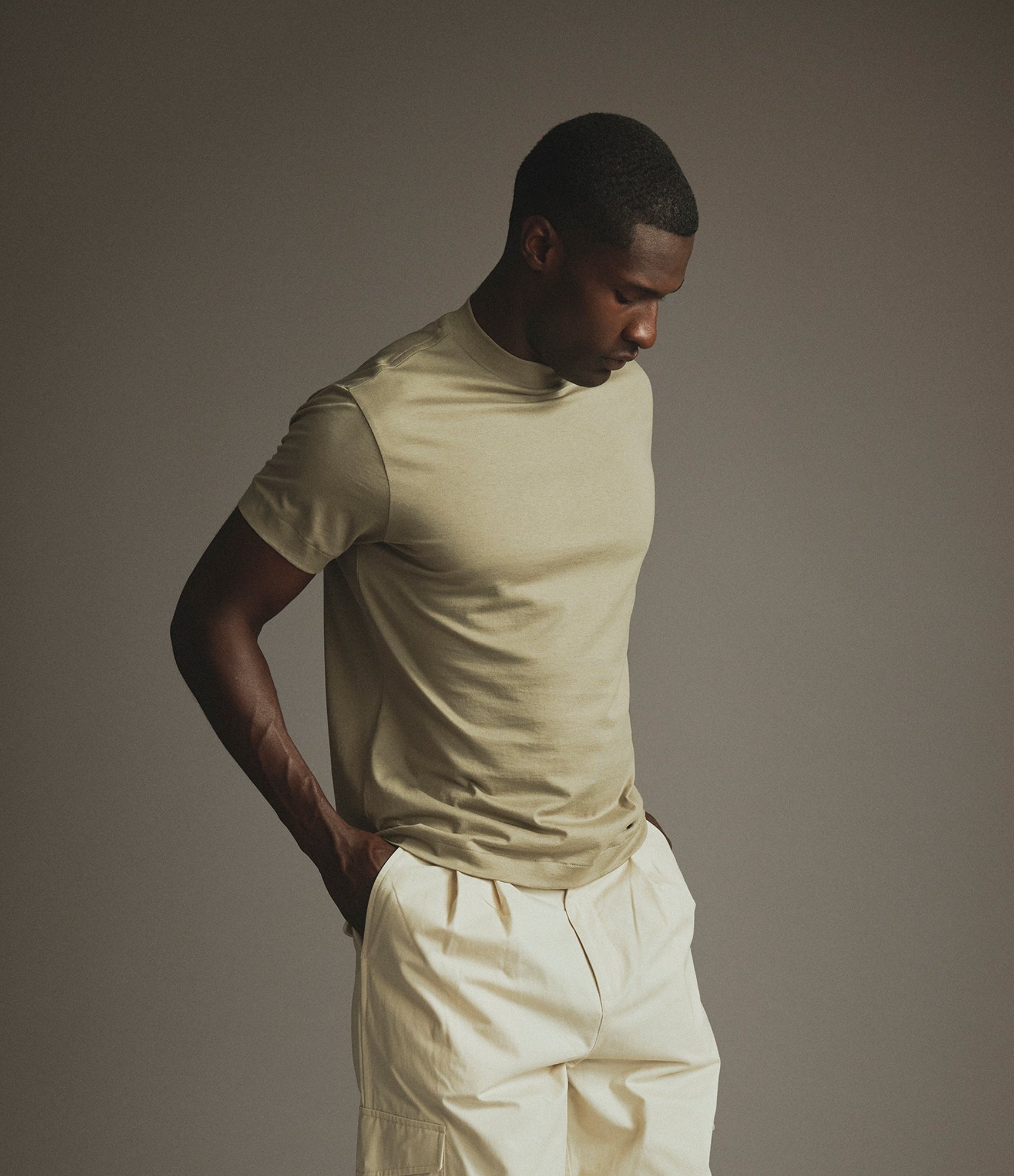 Model wearing the silk hi-neck t-shirt in dried sage