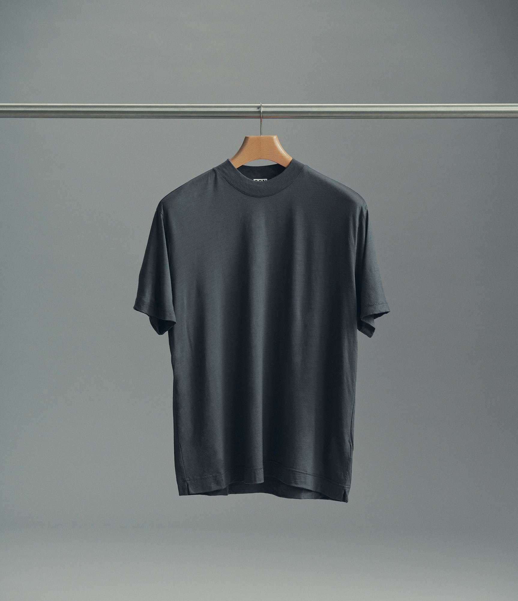 Wool hi-neck t-shirt in asphalt hanging on a rack